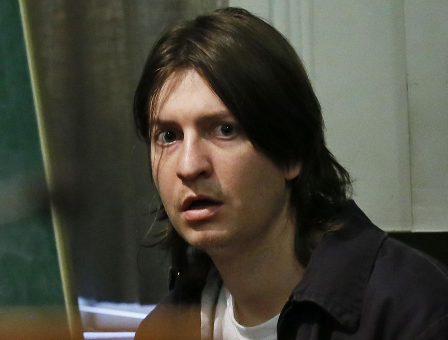 Christian Costello, accused of fatally stabbing his father, former Oklahoma Labor Commissioner Mark Costello, in August of 2015, waits for a competency hearing in an Oklahoma County courtroom in Oklahoma City, Wednesday, Aug. 10, 2016. Costello was ordered to be returned to a state mental hospital to be examined by a psychiatrist hired by prosecutors. (AP Photo/Sue Ogrocki)