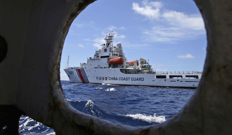 In this March 29, 2014 file photo, a Chinese Coast Guard ship attempts to block a Philippine government vessel as the latter tries to enter the Second Thomas Shoal in the South China Sea to relieve Philippine troops and resupply provisions. China’s simmering feud with South Korea over the deployment of an American missile defense system is just the latest in a string of foreign policy challenges piling up on President Xi Jinping’s desk as he prepares to host the annual summit of the G20 nations next month. North Korea, Taiwan, the South China Sea and the United States all pose difficult challenges and pose the risk of exhausting China’s crisis management capacity and the ruling Communist Party’s aura of total control. (AP Photo/Bullit Marquez, File)