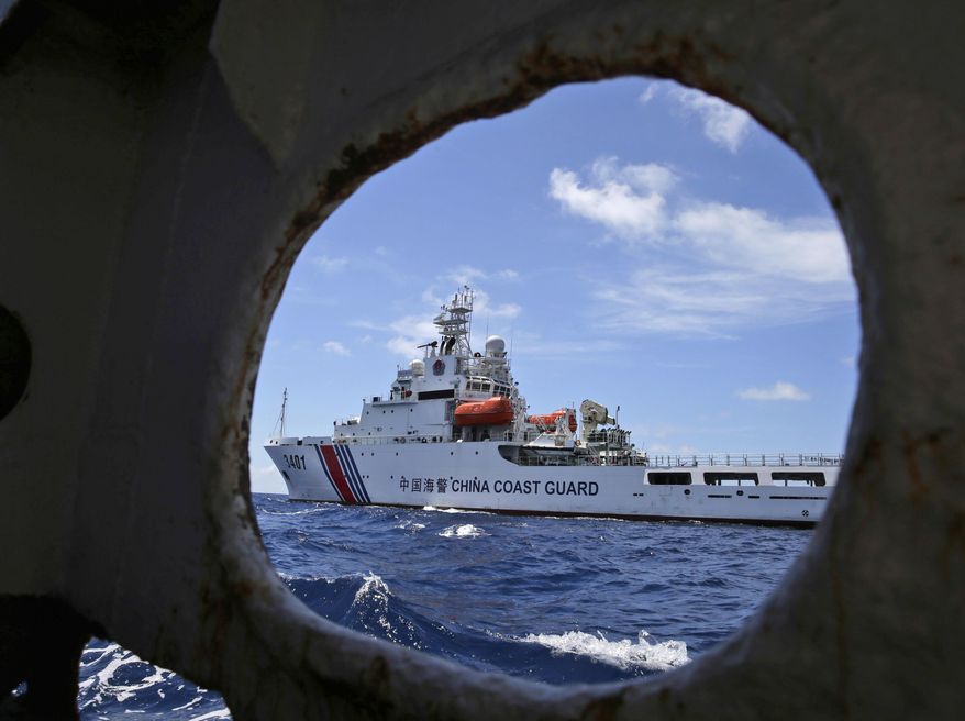 In this March 29, 2014 file photo, a Chinese Coast Guard ship attempts to block a Philippine government vessel as the latter tries to enter the Second Thomas Shoal in the South China Sea to relieve Philippine troops and resupply provisions. China’s simmering feud with South Korea over the deployment of an American missile defense system is just the latest in a string of foreign policy challenges piling up on President Xi Jinping’s desk as he prepares to host the annual summit of the G20 nations next month. North Korea, Taiwan, the South China Sea and the United States all pose difficult challenges and pose the risk of exhausting China’s crisis management capacity and the ruling Communist Party’s aura of total control. (AP Photo/Bullit Marquez, File)