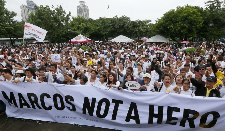 Protesters gather at Rizal Park during a rally to oppose the burial of the late Philippine dictator Ferdinand Marcos at the Heroes' Cemetery in Manila, Philippines, Sunday, Aug. 14, 2016. It was the biggest gathering so far since President Rodrigo Duterte ordered the burial of Marcos with full military honors and with the opposition announcing its plan to file a petition with the Supreme Court. (AP Photo/Bullit Marquez)