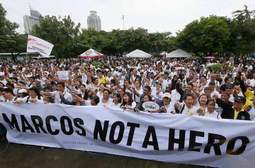 Protesters gather at Rizal Park during a rally to oppose the burial of the late Philippine dictator Ferdinand Marcos at the Heroes' Cemetery in Manila, Philippines, Sunday, Aug. 14, 2016. It was the biggest gathering so far since President Rodrigo Duterte ordered the burial of Marcos with full military honors and with the opposition announcing its plan to file a petition with the Supreme Court. (AP Photo/Bullit Marquez)
