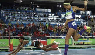 Bahamas&#39; Shaunae Miller falls over the finish line to win gold ahead of United States&#39; Allyson Felix, right, in the women&#39;s 400-meter final during the athletics competitions of the 2016 Summer Olympics at the Olympic stadium in Rio de Janeiro, Brazil, Monday, Aug. 15, 2016. (AP Photo/Matt Slocum)
