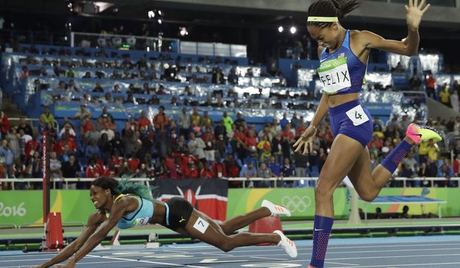 Bahamas&#x27; Shaunae Miller falls over the finish line to win gold ahead of United States&#x27; Allyson Felix, right, in the women&#x27;s 400-meter final during the athletics competitions of the 2016 Summer Olympics at the Olympic stadium in Rio de Janeiro, Brazil, Monday, Aug. 15, 2016. (AP Photo/Matt Slocum)
