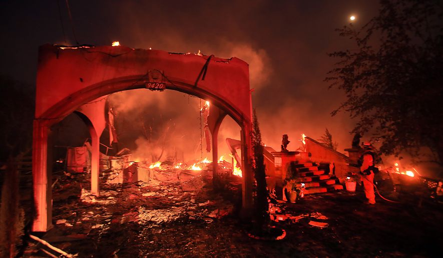 A house off Winchester Street in Lower Lake, Calif., is in ruins due to the Clayton fire Sunday, Aug. 14, 2016. (Kent Porter/The Press Democrat via AP)