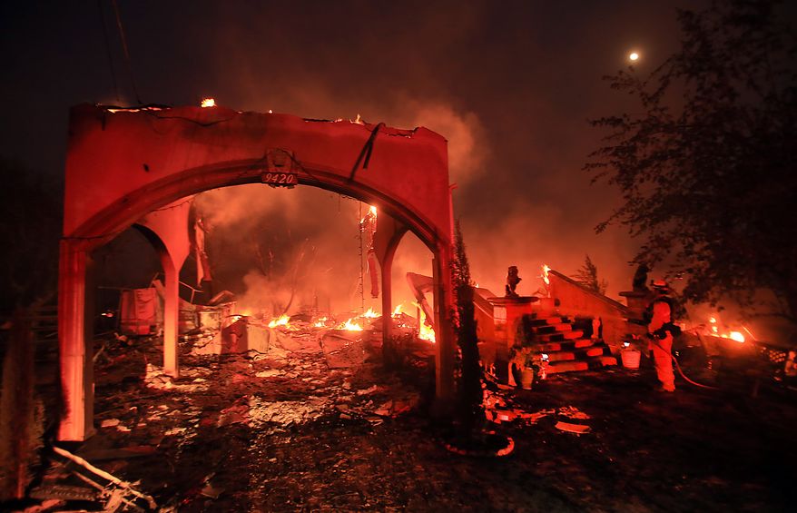 A house off Winchester Street in Lower Lake, Calif., is in ruins due to the Clayton fire Sunday, Aug. 14, 2016. (Kent Porter/The Press Democrat via AP)
