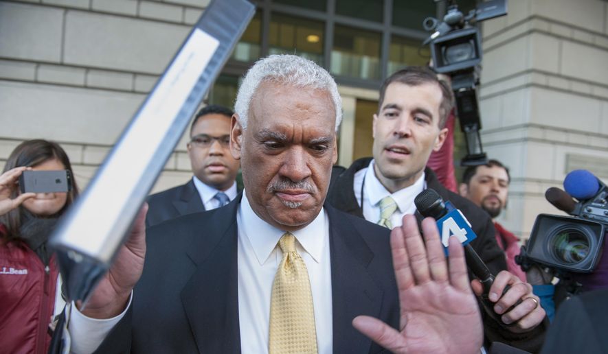 In this March 10, 2014, file photo, Jeffrey Thompson holds up his hands to indicate he will not speak to reporters as leaves federal court in Washington, after being charged in a criminal information with two conspiracy offenses stemming from an ongoing investigation. Thompson, a District of Columbia businessman who poured millions of illegal dollars into city, state and federal elections has been sentenced to three months in prison. (AP Photo/Cliff Owen, File)