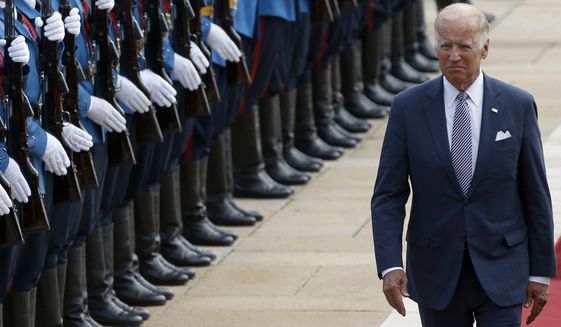 Vice President Joseph R. Biden reviews the honor guard upon his arrival at the Serbia Palace to meet with Prime Minister Aleksandar Vucic in Belgrade on Tuesday. (Associated Press)