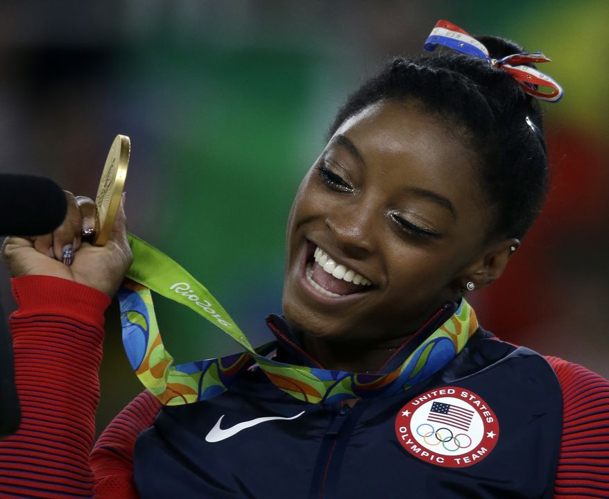 United States&#39; Simone Biles displays her gold medal for floor during the artistic gymnastics women&#39;s apparatus final at the 2016 Summer Olympics in Rio de Janeiro, Brazil, Tuesday, Aug. 16, 2016. The World Anti-Doping Agency (WADA) on Sept. 13 said a Russian espionage group was behind a cybersecurity breach that resulted in the private health records of U.S. Olympic athletes being leaked online, including that of Ms. Biles. (AP Photo/Rebecca Blackwell)