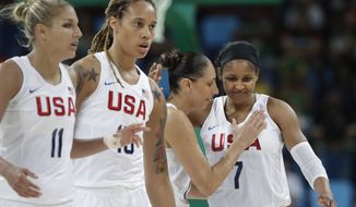 United States&#39; Diana Taurasi, second from right, pats teammate Maya Moore as they walk off the court during a women&#39;s quarterfinal round basketball game against Japan at the 2016 Summer Olympics in Rio de Janeiro, Brazil, Tuesday, Aug. 16, 2016. (AP Photo/Eric Gay)