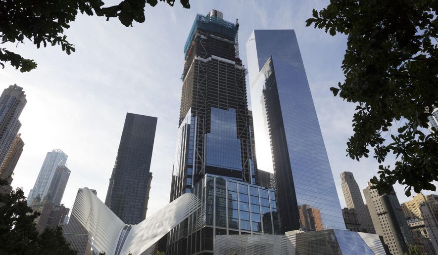 This Monday, Aug. 15, 2016, photo shows the World Trade Center Transportation Hub, lower left, and commercial office buildings 3 World Trade Center, center, and 4 World Trade Center, right, which are part of the rebuilt site, in New York. The Westfield World Trade Center, a retail mall, will open Tuesday, Aug. 16, in the three buildings. (AP Photo/Mark Lennihan)