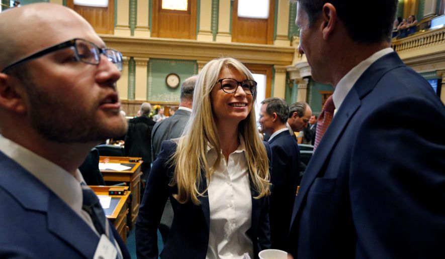 Colorado Rep. Brittany Pettersen (center) speaks with House Democrats&#39; Chief of Staff Ian Silverii (left) and a visitor on the opening day of the Colorado legislative session in Denver this year. (Associated Press)
