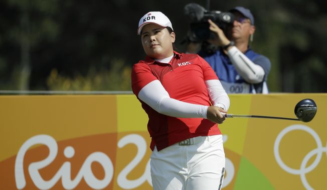 Inbee Park of South Korea, watches her tee shot on the 3rd hole during the first round of the women&#x27;s golf event at the 2016 Summer Olympics in Rio de Janeiro, Brazil, Wednesday, Aug. 17, 2016. (AP Photo/Chris Carlson)