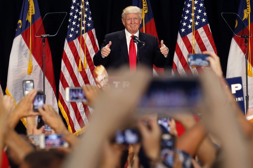 Republican presidential candidate Donald Trump reacts to the crowd as he arrives to deliver a campaign speech in Charlotte, N.C. Thursday, Aug. 18, 2016. (AP Photo/Gerald Herbert)