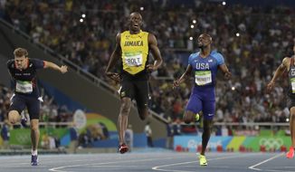 Usain Bolt from Jamaica, second left, crosses the line to win the gold medal in the men&#39;s 200-meter final ahead of second placed Canada&#39;s Andre De Grasse, right, and third placed France&#39;s Christophe Lemaitre, left, during the athletics competitions of the 2016 Summer Olympics at the Olympic stadium in Rio de Janeiro, Brazil, Thursday, Aug. 18, 2016. (AP Photo/David J. Phillip)