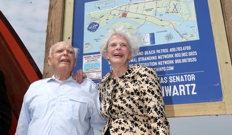 Former Texas Senator A.R. "Babe" Schwartz and his wife, Marilyn, pose for photos Thursday, May 26, 2016, during the dedication of Babe's Beach in Galveston, Texas. Schwartz is working to find ways for the Galveston Park Board to cooperate with other beach communities to restore money taken away by the Legislature in 2015. He believes access to public beaches has been under constant assault since the day the Open Beaches Act was enacted in 1959. (Jennifer Reynolds/The Galveston County Daily News via AP)