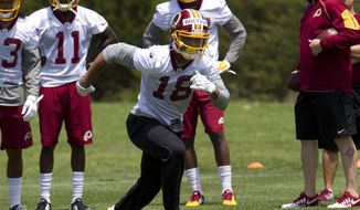 FILE - In this May 14, 2016 file photo, Washington Redskins wide receiver Josh Doctson, 18, works out during NFL football rookie minicamp in Ashburn, Va. Doctson is inching his way back from an Achilles tendon injury, though the Washington Redskins still don’t know when the wide receiver will be ready to practice with the team, let alone play in a game. (AP Photo/Jose Luis Magana, File)