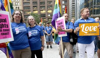 Supporters of gay marriage in Wisconsin and Indiana attend a rally at the federal plaza in Chicago on Aug. 25, 2014. The Chicago-based 7th U.S. Circuit Court of Appeals will hear arguments Aug. 26 on gay marriage fights from Indiana and Wisconsin, setting the stage for one ruling. Each case deals with whether statewide gay marriage bans violate the Constitution. (Associated Press) **FILE**