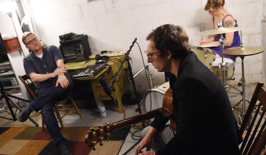 From left, Matt Jones and musician Matt Vial chat in Jones' Ypsilanti, Mich., basement studio as artist Sarah Campbell sketches as they prepare to do a recording for the River Street Anthology on Monday, July 25, 2016. (Melanie Maxwell/The Ann Arbor News via AP)
