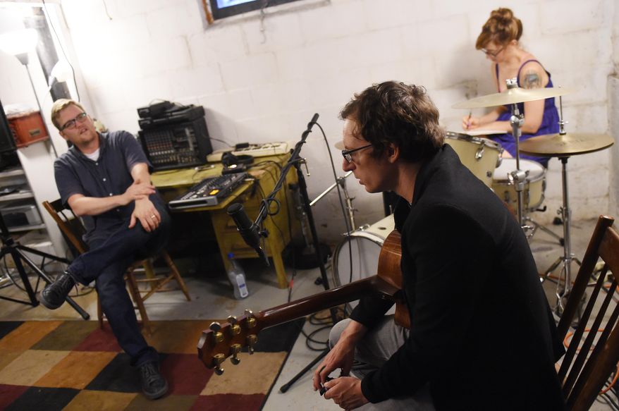From left, Matt Jones and musician Matt Vial chat in Jones' Ypsilanti, Mich., basement studio as artist Sarah Campbell sketches as they prepare to do a recording for the River Street Anthology on Monday, July 25, 2016. (Melanie Maxwell/The Ann Arbor News via AP)