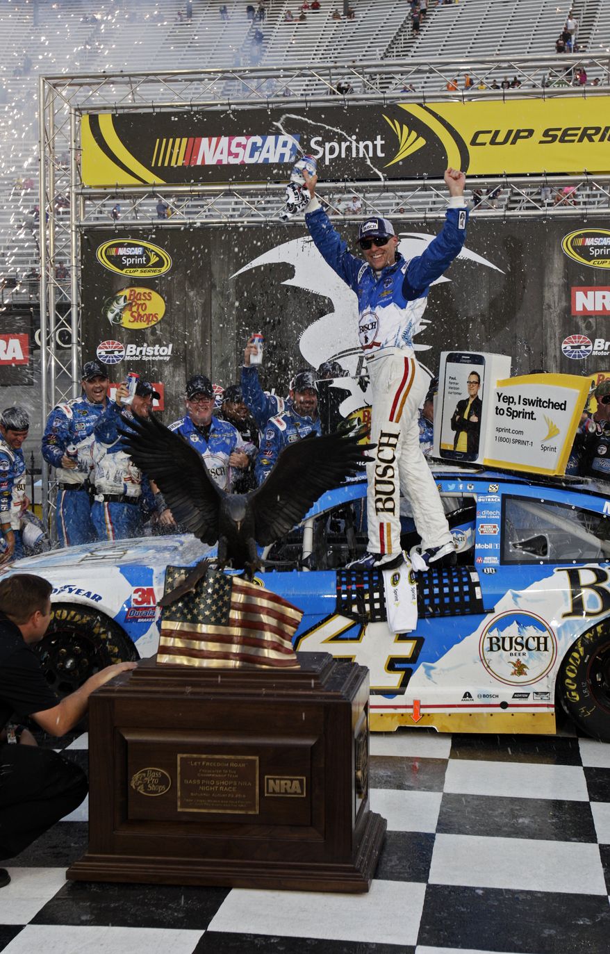 Kevin Harvick celebrates after winning a NASCAR Sprint Cup Series auto race, Sunday, Aug. 21, 2016 in Bristol, Tenn. The race was delayed Saturday night due to severe weather. (AP Photo/Wade Payne)