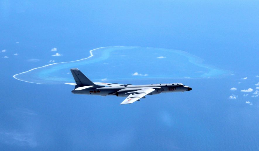 In this undated file photo released by Xinhua News Agency, a Chinese H-6K bomber patrols the islands and reefs in the South China Sea.  (Liu Rui/Xinhua via AP, File) **FILE**