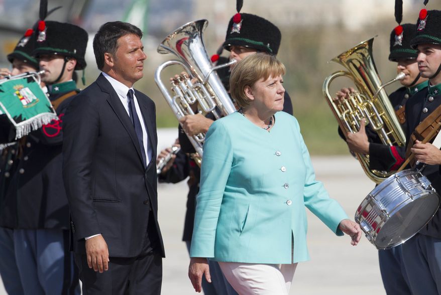 Italian Premier Matteo Renzi, left, and German Chancellor Angela Merkel review the honor guard at Naples&#39; Capodichino international airport, Monday, Aug. 22, 2016. The leaders of Italy, France and Germany headed Monday to one of the birthplaces of European unity in a symbolic bid to relaunch the European project following Britain&#39;s decision to leave the EU. (AP Photo/Riccardo De Luca)
