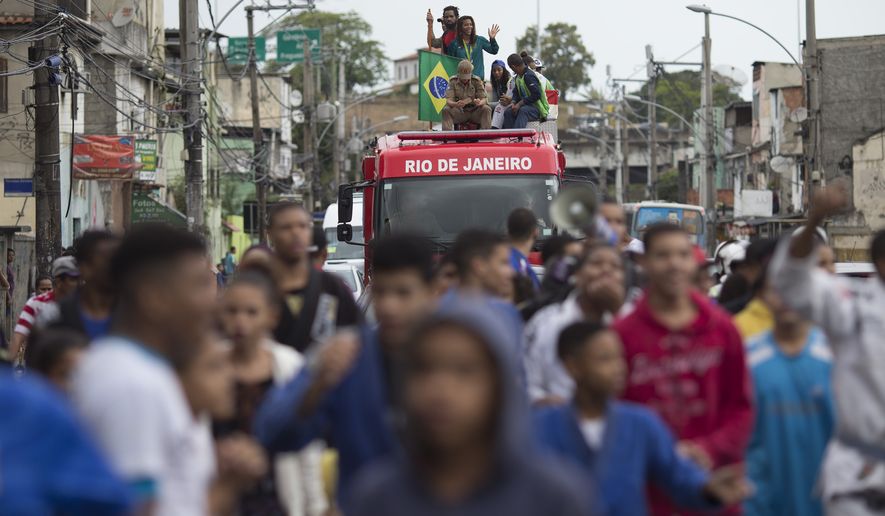 Brazilian judo gold medalist Rafaela Silva is given a hero&#39;s welcome as she rides a fire truck into the Cidade de Deus &quot;City of God&quot; slum in Rio de Janeiro, Brazil, Monday, Aug. 22, 2016. Silva who grew up in the violent, poverty stricken slum, won special mention from IOC president Thomas Bach, saying she&#39;s an inspiration across the world.&quot; (AP Photo/Leo Correa)
