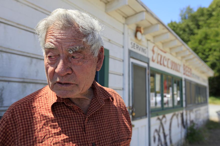 FILE - In this Friday July 15, 2011, file photo, park resident Frank Quan stands outside the store he runs at China Camp State Park, Calif. Quan, the last of the China Camp shrimpers, the remaining resident of a shrimping village established by Chinese immigrants on the northern shore of San Francisco Bay, died on Aug. 15, 2016. He was 90. (AP Photo/Eric Risberg, File)