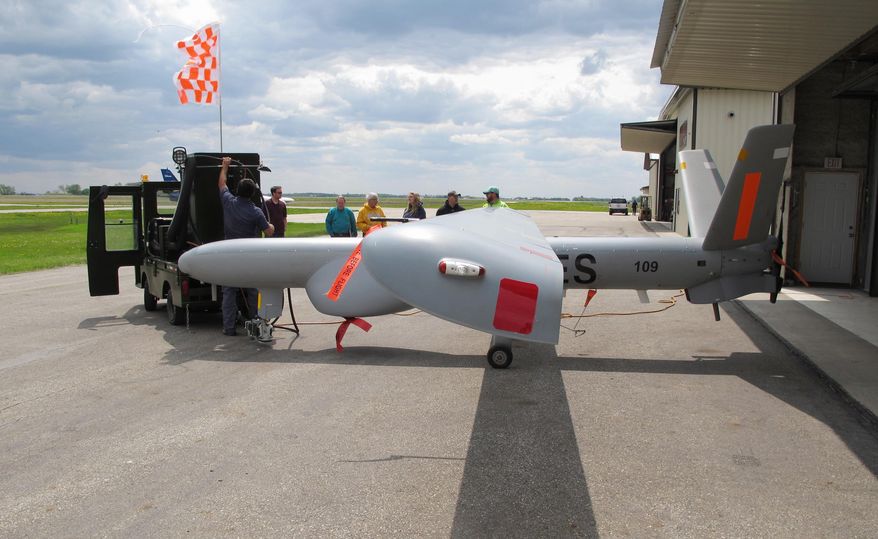 FILE - In this May 20, 2016, file photo, an Israeli-built Elbit Systems Hermes 450 unmanned aircraft is towed out of a hangar at the Hillsboro, N.D. airport before its first flight to collect agriculture data. The high-flying drone that was brought to North Dakota in May is now part of a trial run to see if can help restore power to areas hit by natural disasters. Officials involved in the Xcel Energy test program say the larger drone's ability to cover more ground, collect more data and fly at night is expected to help the company move crews, materials and equipment quickly and safely. (AP Photo/Dave Kolpack, File)