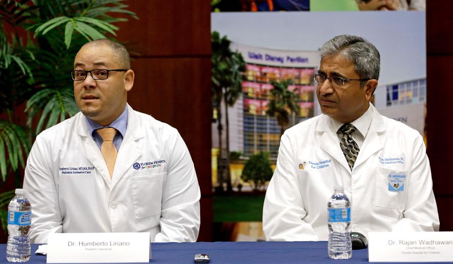 Dr. Humberto Liraino, left, makes comments during a news conference as Dr. Rajan Wadhawan listens, at Florida Hospital, Tuesday, Aug. 23, 2016, in Orlando, Fla. The doctor spoke about the treatment of Sebastian DeLeon, a patient that has survived a brain-eating amoeba that kills most people who contract it. (AP Photo/John Raoux)