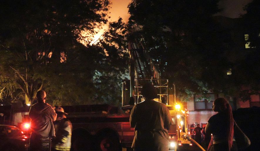 Chicago firefighters battle an apartment fire in the 8100 block of South Essex Avenue in the South Chicago neighborhood early on Tuesday, Aug. 23, 2016. The fire at a Chicago apartment building that appears to have been deliberately set killed multiple people Tuesday, police said. (Alexandra Chachkevitch/Chicago Tribune via AP)