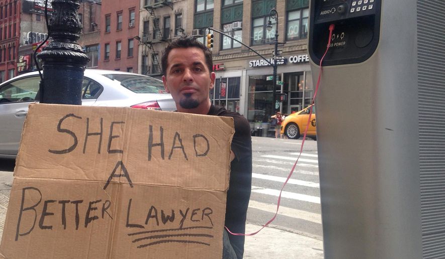 In this Aug. 16, 2016 photo, Matthew Kane charges his phone while panhandling at a wi-fi kiosk at 39th Street and 8th Avenue in New York. Kane, who said he's couch surfing in New York after moving here recently from Pittsburgh, was taking advantage of an ambitious public-private partnership that has converted hundreds of obsolete New York City phone booths into wi-fi kiosks offering free internet access, phone charging and domestic calls.. (AP Photo/Karen Matthews)