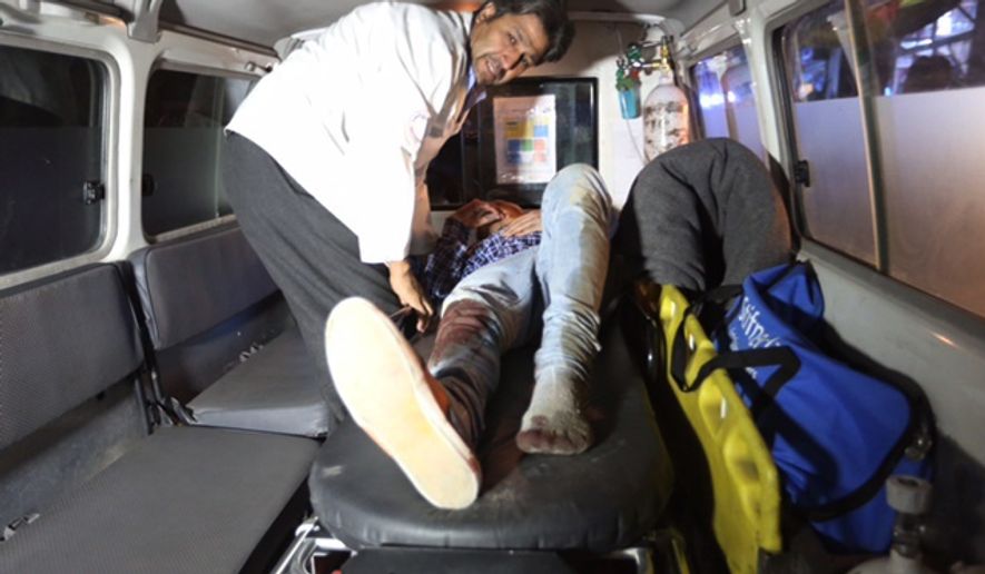 A wounded person is treated in an ambulance after a complex Taliban attack on the campus of the American University in the Afghan capital Kabul on Wednesday, Aug. 24, 2016. We are trying to assess the situation, President Mark English told The Associated Press. (AP Photo/Rahmat Gul)