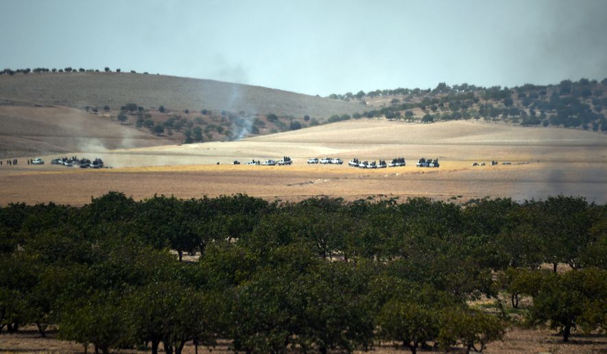 Turkish army tanks and Turkey-backed Syrian opposition forces move toward the Syrian border as pictured from Karkamis, Turkey, Wednesday, Aug. 24, 2016. Turkey&#x27;s military launched an operation before dawn Wednesday to clear a Syrian border town from Islamic State militants, and a private Turkish TV station reported that a small number of Turkish special forces had crossed into Syria as part of the operation.The operation was launched hours before Vice President Joe Biden was due in Ankara for talks that include developments in Syria.(AP Photo)