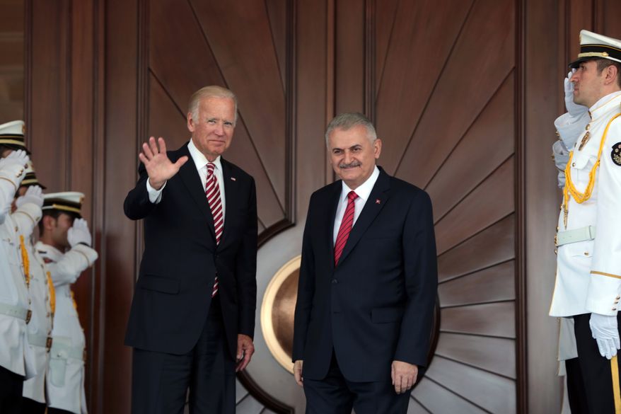 Vice President Joe Biden waves after he was greeted by Turkish Prime Minister Binali Yildirim on Wednesday in Ankara. (Associated Press)