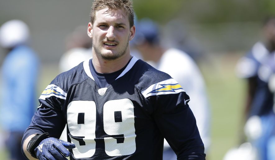 FILE - In this May 13, 2016, file photo, San Diego Chargers rookie defensive end Joey Bosa trains during an NFL football rookie training camp in San Diego. The Chargers have withdrawn their contract offer to first-round draft pick Joey Bosa and will restructure a new deal that takes into account his absence from the team.The Chargers' statement Wednesday, Aug. 24, 2016, said they believe "Joey will be unable to contribute for the full 16-game season without the adequate time on the practice field, in the classroom, and in preseason games."(AP Photo/Gregory Bull, File)