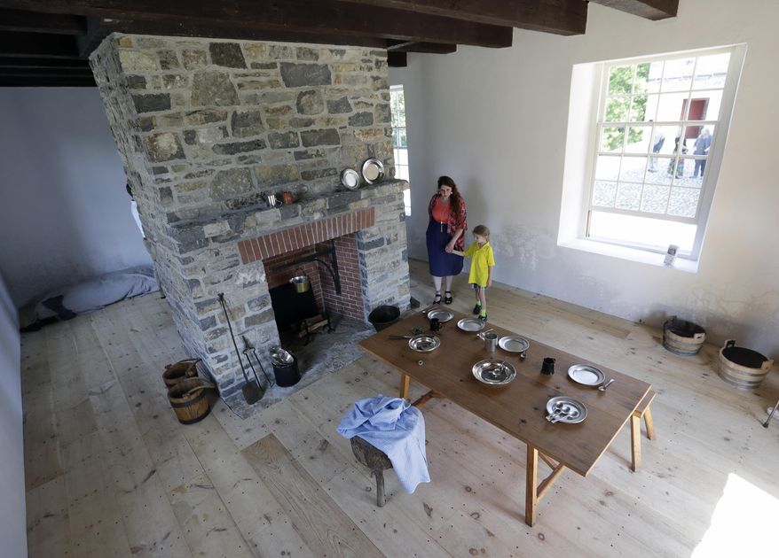 Bernadette Weaver, of the Friends of Johnson Hall, and her son Tavin walk inside a restored stone house at Johnson Hall State Historic Site, Wednesday, Aug. 24, 2016, in Johnstown, N.Y. State and local officials marked the restoration of the historic building at the Colonial-era site in the Mohawk Valley. Johnson Hall was the estate of Sir William Johnson, an Irish immigrant who was one of the wealthiest and most influential men in North America before the Revolutionary War. (AP Photo/Mike Groll)