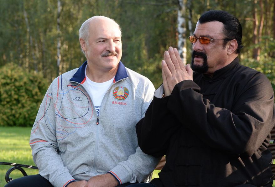 In this photo taken Wednesday, Aug. 24, 2016, Belarusian President Alexander Lukashenko, left, meets with Hollywood actor and producer Steven Seagal in the presidential residence of Drozdy, outside Minsk, Belarus. Belarus' farm-loving President Alexander Lukashenko has treated American action hero Steven Seagal to a harvest of carrots and watermelons at his out-of-town residence. (Andrei Stasevich/Pool Photo via AP)