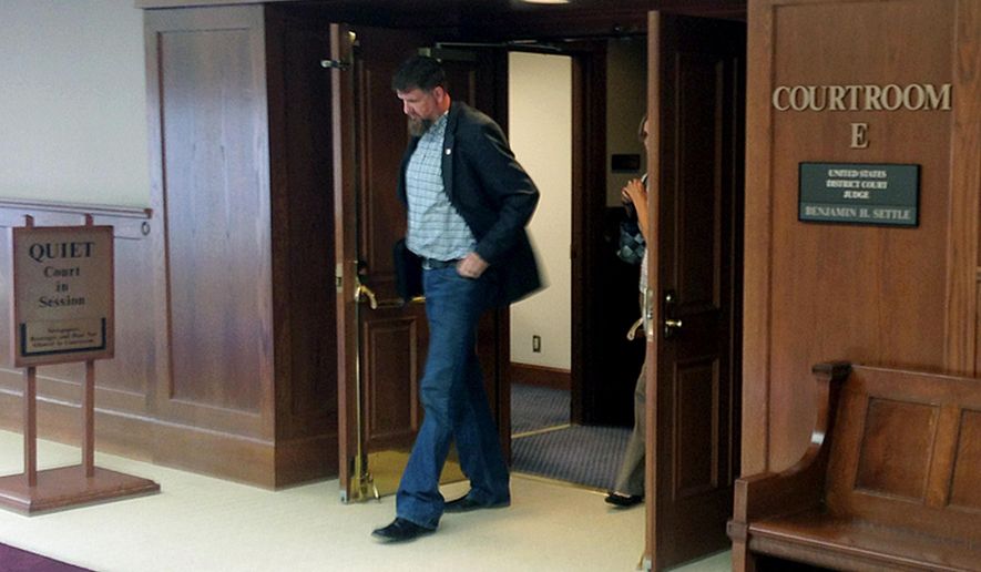 Former National Guard soldier Darryl Lee Wright leaves a courtroom at the U.S. District Court in Tacoma, Wash., where he faced two fraud charges Thursday, Aug. 25, 2016. Federal prosecutors say Wright lied his way to a Purple Heart and hundreds of thousands of dollars in government benefits. (AP Photo/Gene Johnson)