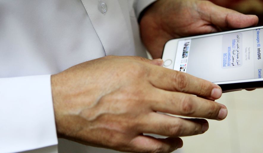 Human rights activist Ahmed Mansoor shows Associated Press journalists a screenshot of a spoof text message he received in Ajman, United Arab Emirates, on Thursday, Aug. 25, 2016. Mansoor was recently targeted by spyware that can hack into Apple&#39;s iPhone handset. The company said Thursday it was updated its security. The text message reads: &quot;New secrets on the torture of Emirati citizens in jail.&quot; (AP Photo/Jon Gambrell)