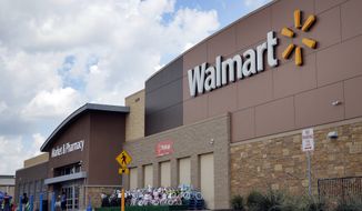 Persons walk in and out of a Wal-Mart store, Friday, Aug. 26, 2016, in Dallas. (AP Photo/Tony Gutierrez) ** FILE **