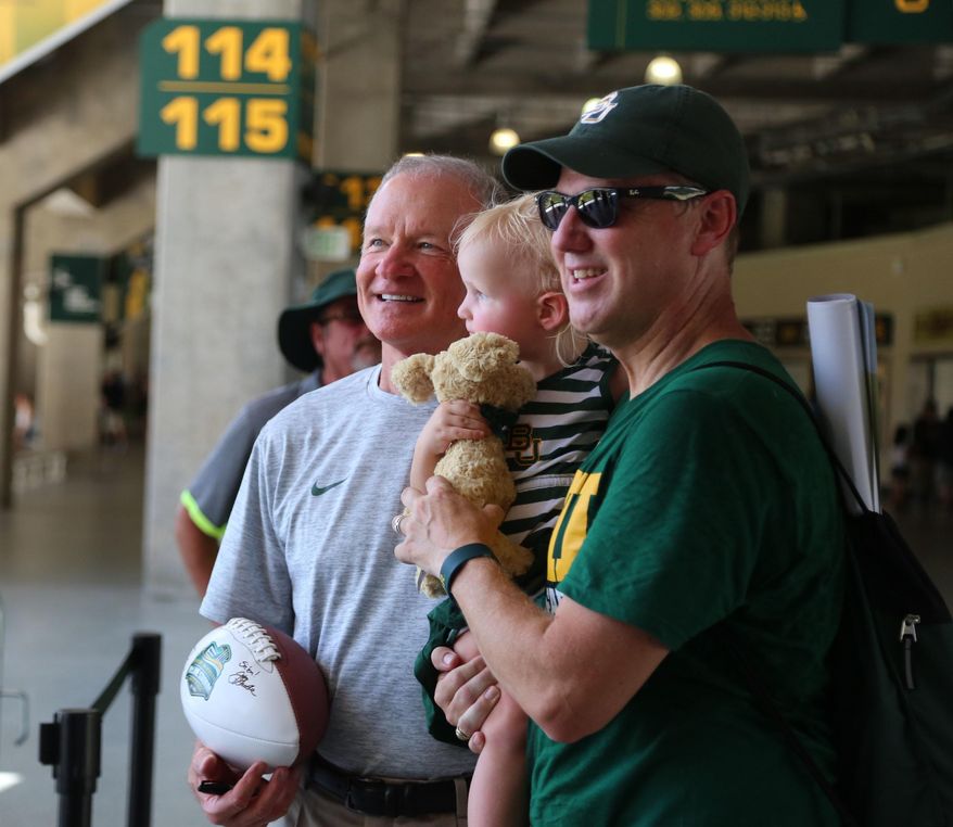 In this Aug. 6, 2016, photo, acting head coach Jim Grobe poses for a photo during the annual "Meet the Bear's," at McLane Stadium in Waco, Texas. Thousands of Baylor fans received autographs and visited with the 2016 football team. (Rod Aydelotte/Waco Tribune Herald, via AP) /Waco Tribune-Herald via AP)