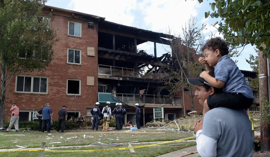 People survey the damage of the Aug. 10 explosion at the Flower Branch Apartments in Silver Spring, Maryland, that injured dozens and left seven people dead, including two children. (associated Press)