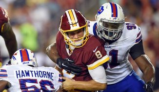 Quarterbacks like the Washington Redskins&#39; Kirk Cousins, are protected by new rules that produce 15-yard penalties for hitting from the shoulders up or knees down. (Associated Press)