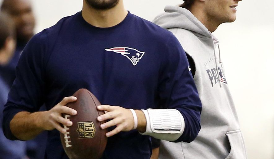 FILE- In this Jan. 23, 2015, file photo, New England Patriots backup quarterback Jimmy Garoppolo, left, holds a football as starting quarterback Tom Brady, right, stands by during a walkthrough at the NFL football team's facility in Foxborough, Mass. Brady will have to sit out the first four games of this season for his role in the "Deflategate" scandal. Garoppolo performs in Brady's absence. (AP Photo/Elise Amendola, File)
