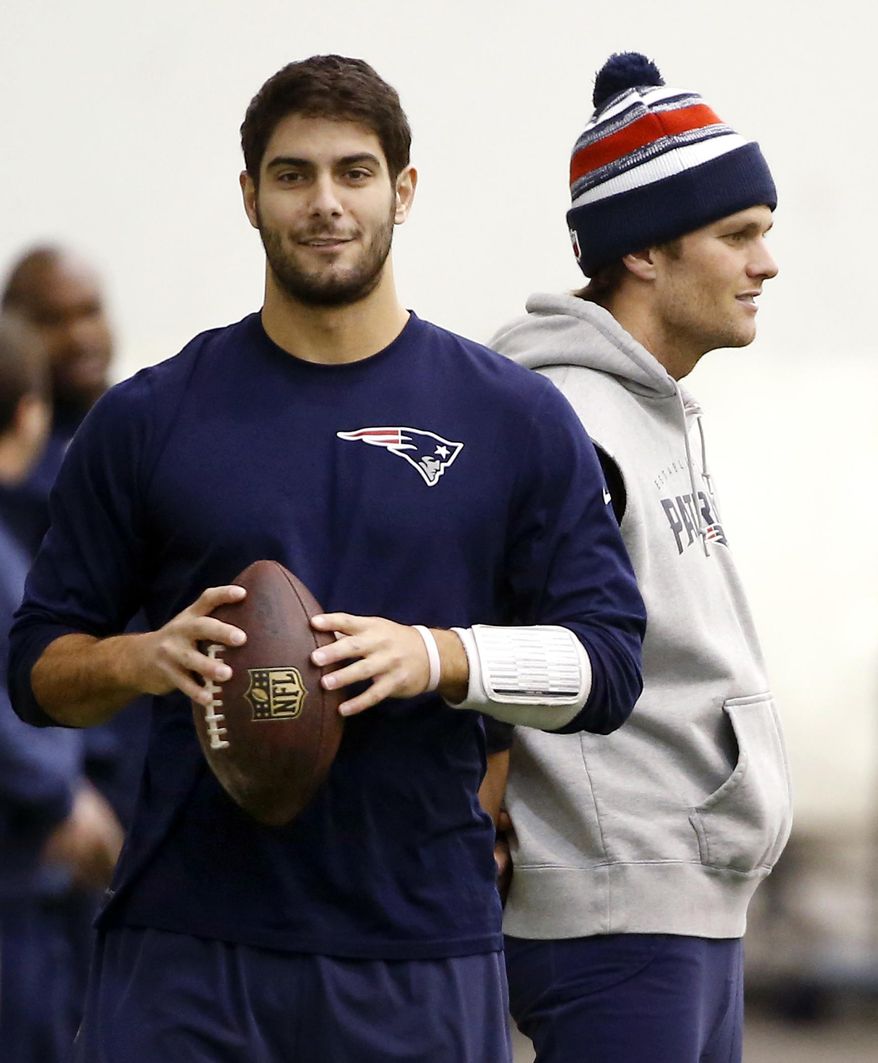 FILE- In this Jan. 23, 2015, file photo, New England Patriots backup quarterback Jimmy Garoppolo, left, holds a football as starting quarterback Tom Brady, right, stands by during a walkthrough at the NFL football team's facility in Foxborough, Mass. Brady will have to sit out the first four games of this season for his role in the "Deflategate" scandal. Garoppolo performs in Brady's absence. (AP Photo/Elise Amendola, File)