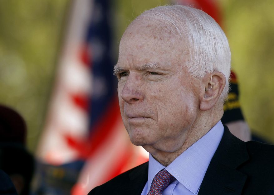 FILE - In this Monday, May 30, 2016, file photo, Sen. John McCain, R-Ariz, looks on during a Phoenix Memorial Day Ceremony at the National Memorial Cemetery of Arizona in Phoenix. A challenge to longtime U.S. Sen. McCain leads the lists of contests drawing attention in Tuesday's Arizona primary election. (AP Photo/Ralph Freso, File)