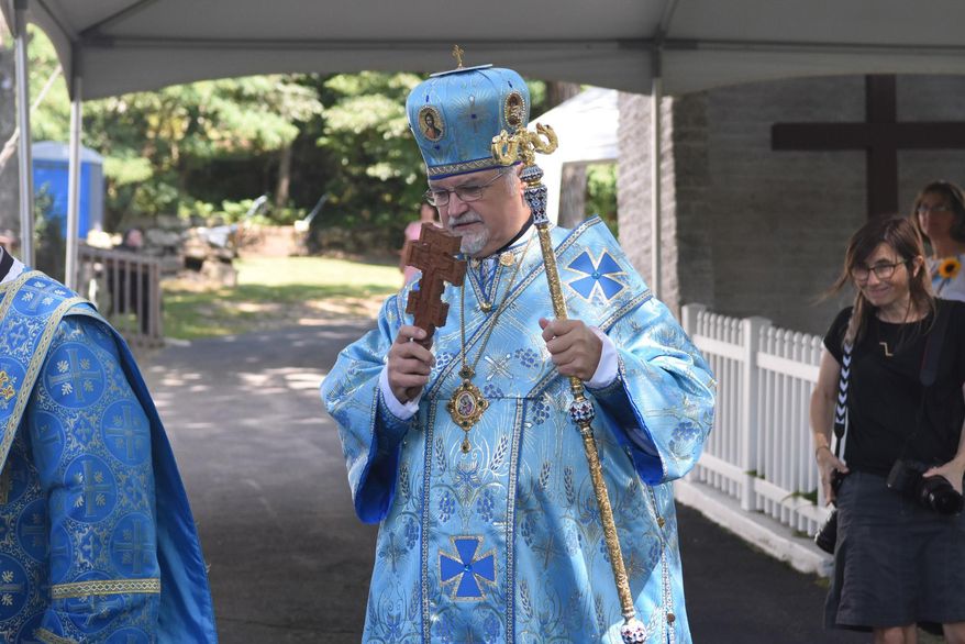 Most Reverend Stefan Soroka, archbishop of the Ukrainian Catholic Archeparchy of Philadelphia and Metropolitan of Ukrainian Catholics in the United States, blesses those gathered outside of the Assumption of the Blessed Virgin Mary Ukrainian Catholic Church as they watch the procession going into the church for the Divine Liturgy at noon in Centralia, Pa., Sunday, Aug. 28, 2016. The church has been named a holy site of pilgrimage by Major Archbishop Sviatoslav Shevchuk and hosted its first pilgrimage on Sunday. (Jacqueline Dormer/Republican-Herald via AP)