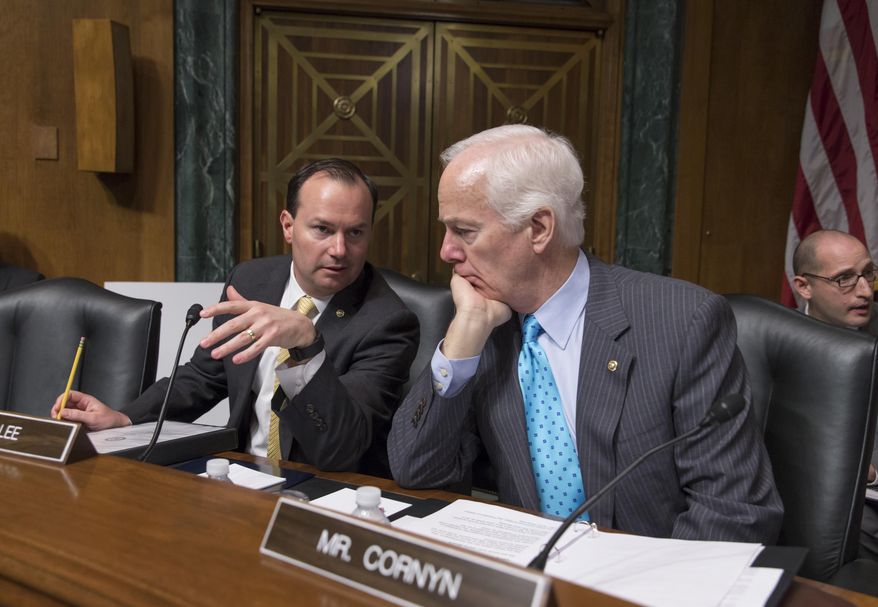 FILE - In this March 16, 2016 file photo, Sen. Mike Lee, R-Utah, left, confers with Sen. John Cornyn, R-Texas. on Capitol Hill in Washington. Hopes for overhauling the nation’s criminal justice system have faded in Congress this year, undercut by a rash of summer shootings involving police and the pressure of election-year politics. Republicans, including Cornyn and Lee, had joined forces with Democrats in hopes of revising the 1980s and ‘90s-era federal “tough on crime” laws by reducing some mandatory sentences for low-level drug offenders and giving judges greater discretion in sentencing. The goal is to reduce overcrowding in the nation’s prisons and save taxpayer dollars. (AP Photo/J. Scott Applewhite, File)
