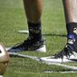 FILE - In this Aug. 10, 2016, file photo, San Francisco 49ers quarterback Colin Kaepernick wears socks depicting police officers as pigs during NFL football training camp at Kezar Stadium in San Francisco. Kaepernick says he has been wearing socks depicting police officers as pigs in protest of &quot;rogue cops&quot; who put the community and other officers at risk.  Kaepernick issued a statement on Twitter on Thursday, Sept. 1, 2016, after photos of him wearing the socks that show a pig dressed in a police hat began circulating on social media. (AP Photo/Ben Margot, File)